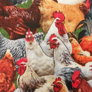 May include: A colourful fabric featuring a pattern of roosters and hens. The fabric features a variety of colours, including red, orange, yellow, brown, white, and black. The roosters and hens are depicted in a realistic style, with detailed feathers and combs.