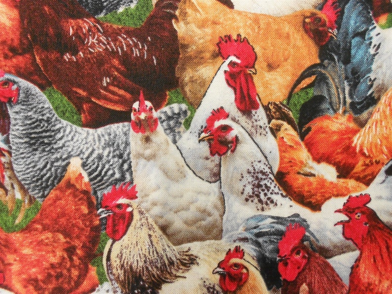 May include: A colourful fabric featuring a pattern of roosters and hens. The fabric features a variety of colours, including red, orange, yellow, brown, white, and black. The roosters and hens are depicted in a realistic style, with detailed feathers and combs.
