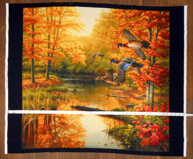 May include: A painting of a forest scene with a stream running through it. The trees are in autumn colors of orange, yellow, and red. There are three ducks flying over the stream.