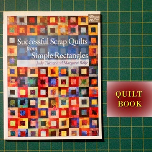 May include: A book titled "Successful Scrap Quilts from Simple Rectangles" by Judy Turner and Margaret Rolfe. The book cover features a colorful patchwork quilt design with a variety of squares and rectangles.