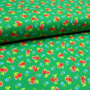 May include: Green fabric with a repeating pattern of red and blue flowers. The fabric has a subtle texture.