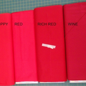 May include: Four fabric swatches in different shades of red, labeled "Poppy", "Red", "Rich Red", and "Wine".