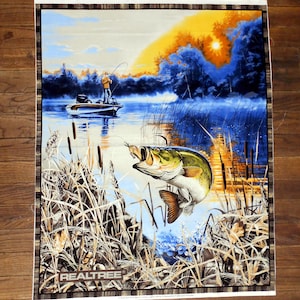 May include: A fabric panel featuring a vibrant fishing scene. A fisherman in a boat casts a line, with a large-mouth bass leaping from the water. The background shows a sunset over a lake, with the text "Realtree" at the bottom.