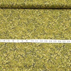 May include: Green fabric with a swirling, abstract pattern. The fabric has a textured surface and is approximately 20 inches wide.