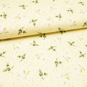 May include: A yellow fabric with a white daisy floral pattern and small gold dots.