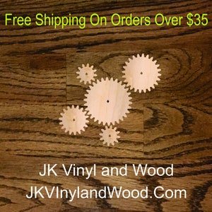 May include: Five wooden gears of different sizes are arranged on a brown wood surface. The largest gear is in the center, with the other four gears surrounding it. The text "Free Shipping On Orders Over $35" is at the top of the image. The text "JK Vinyl and Wood" and "JKVinylandWood.Com" are at the bottom of the image.