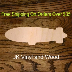 May include: A wooden cutout of a blimp or airship on a brown wood background. The text "Free Shipping On Orders Over $35" and "JK Vinyl and Wood" are visible in the image.