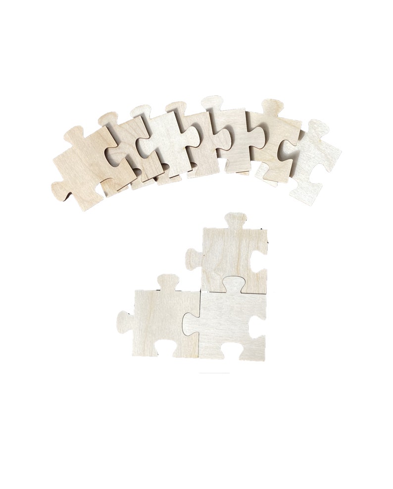 Peut inclure: Un ensemble de pi&egrave;ces de puzzle en bois en forme de point d'interrogation. Les pi&egrave;ces sont dispos&eacute;es en ligne courbe en haut de l'image, et trois pi&egrave;ces sont dispos&eacute;es en forme de triangle en bas de l'image.