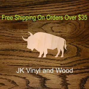 May include: A wooden cutout of a bison silhouette on a brown wood background. The text "Free Shipping On Orders Over $35" is at the top of the image. The text "JK Vinyl and Wood" is at the bottom of the image.