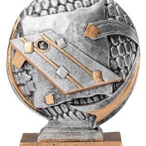 May include: Silver and gold trophy with a geometric design. The trophy has a round base and a square top.