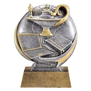 May include: A silver and gold trophy with a globe, a lamp, a book, and a laptop. The trophy is on a gold base.