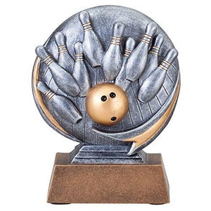May include: Silver bowling trophy with a gold bowling ball and pins. The trophy has a silver base and a gold top.