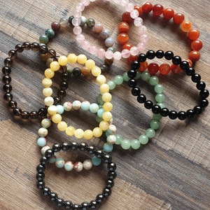 Crystal bracelets: Moss Agate, Green Aventurine, Smoky Quartz, Snakeskin Jasper, Orange Calcite, Rose Quartz, Hematite, Obsidian, Pyrite