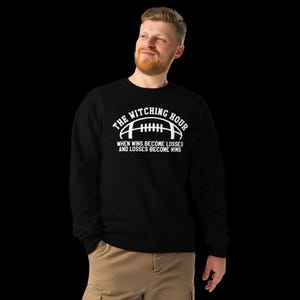 May include: Black sweatshirt with white text that reads "The Witching Hour" with a football graphic and the text "When wins become losses and losses become wins".