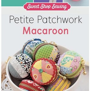 May include: A collection of colorful, fabric patchwork macaroon coin purses with zippers and gold chains. The purses are in a white bowl and the title "Petite Patchwork Macaroon" is visible above the bowl.