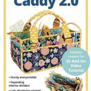 May include: A yellow and blue fabric tote bag with a floral print and the text "Catch All Caddy 2.0". The bag has a handle and multiple pockets. It is designed to organize and carry supplies.