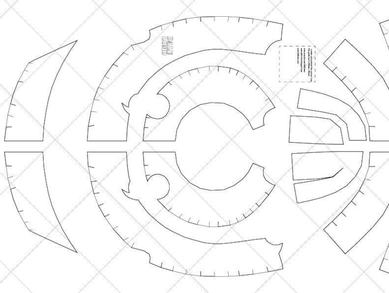 May include: A black and white line drawing pattern for a helmet. The pattern includes multiple pieces that need to be cut out and assembled. The pattern includes measurements in inches.