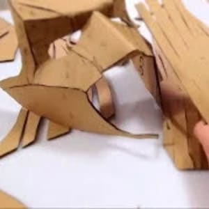 May include: A set of brown cardboard pieces cut into various shapes, likely for a craft project.