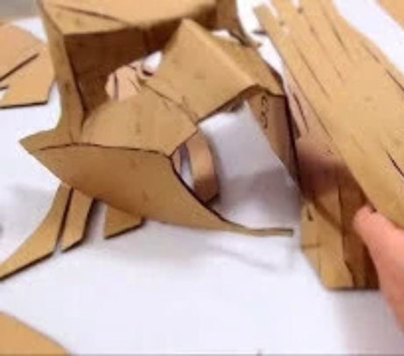 May include: A set of brown cardboard pieces cut into various shapes, likely for a craft project.