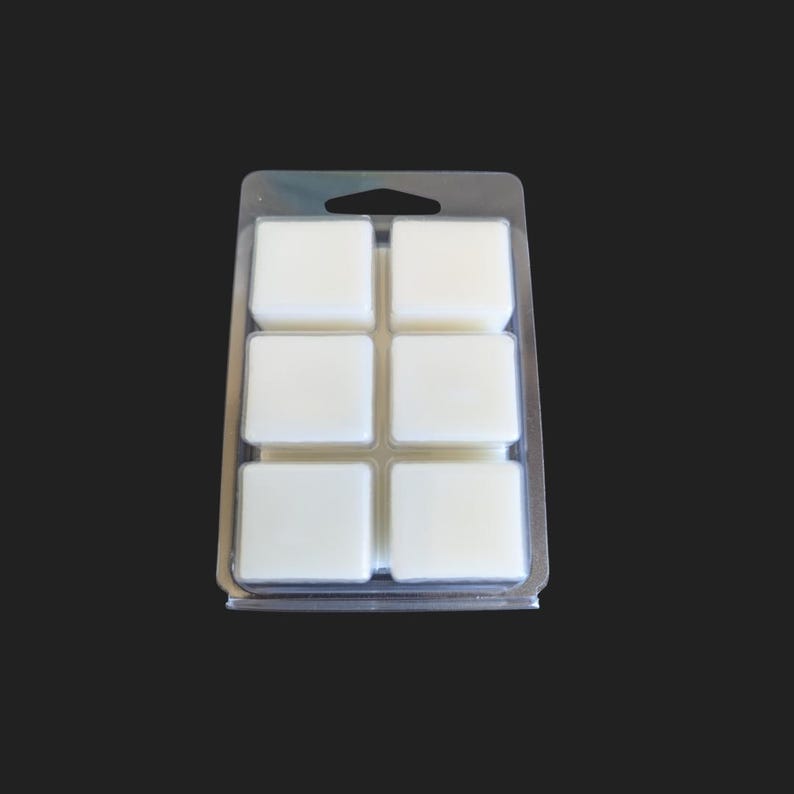 May include: A clear plastic tray with six white wax melts. The tray has a handle on the top.