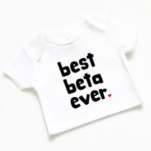May include: White baby onesie with black text that reads "best beta ever" with a small red heart.