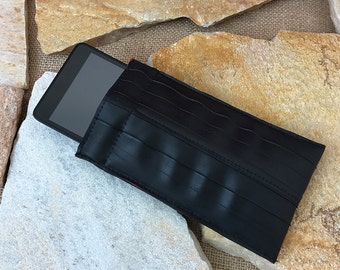 May include: Black phone case made from recycled bicycle tire inner tube with red stitching. The case is designed to protect a tablet or phone.