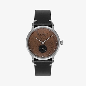 May include: A silver watch with a black leather band and a wooden face. The face has a wood grain pattern and the brand name "AVANT NEW YORK" is printed on it.