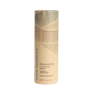 Minimalist sustainable beauty packaging for organic highlighter stick, featuring textured bamboo-inspired design.