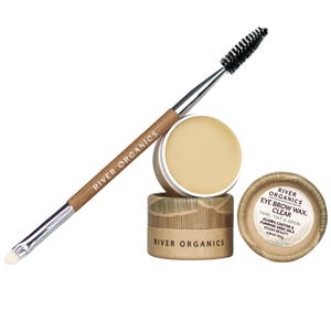 May include: A clear eyebrow wax and applicator brush set. The set includes a small jar of wax, a brush with a spoolie and angled brush, and a lid with product information. The brand name "River Organics" is visible on the brush and packaging.