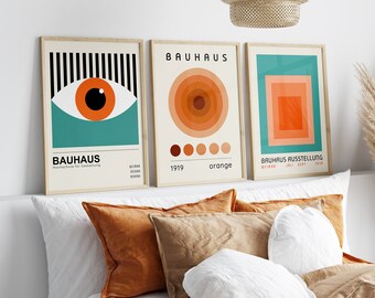 May include: Three framed prints with a Bauhaus theme. The prints feature geometric shapes in orange, teal, and black. The text on the prints reads "Bauhaus" and "Bauhaus Ausstellung".