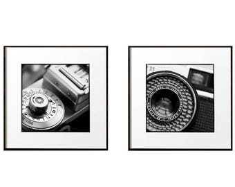 May include: Two black and white close-up photos of an old camera. The first photo shows the camera's shutter speed dial. The second photo shows the camera's lens.