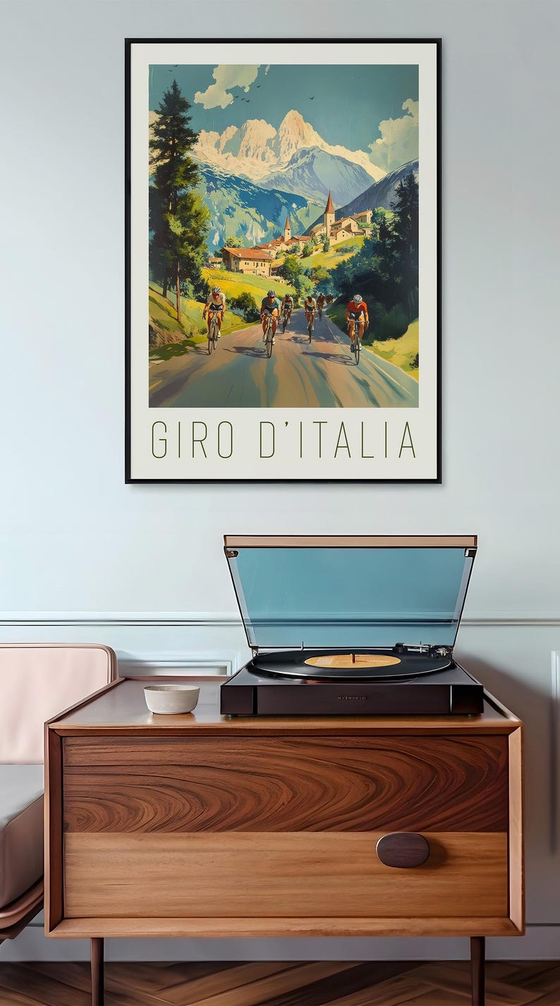 May include: A vintage poster advertising the Giro d'Italia cycling race. The poster features a group of cyclists riding through a mountain pass with a village in the background. The text "GIRO D'ITALIA" is printed at the bottom of the poster.