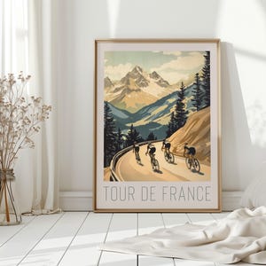 May include: A vintage-style poster with a mountain landscape and cyclists riding up a winding road. The poster is titled "Tour de France".