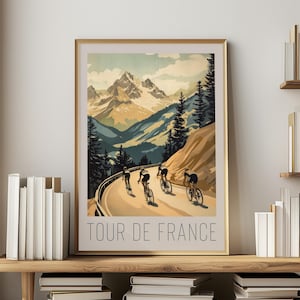 May include: A vintage-style poster featuring a group of cyclists riding up a mountain road. The poster has a blue, green, and brown color scheme and the text "TOUR DE FRANCE" at the bottom.