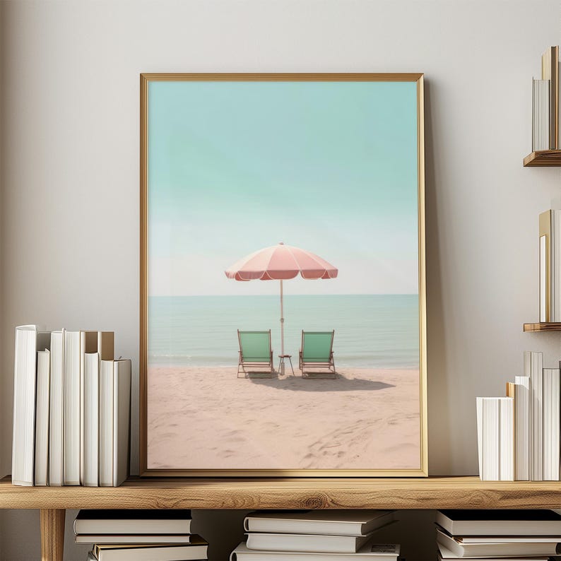 May include: A pink and white striped beach umbrella with two green chairs on a sandy beach with a blue ocean in the background.