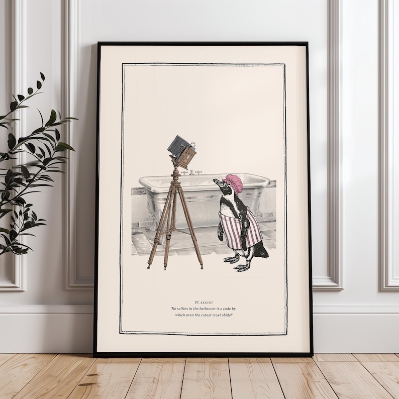 May include: Framed art print featuring a penguin in a pink shower cap and striped robe, posing in front of a vintage camera on a tripod. The background includes a bathtub. The text reads, "No selfies in the bathroom is a code by which even the cutest must abide."