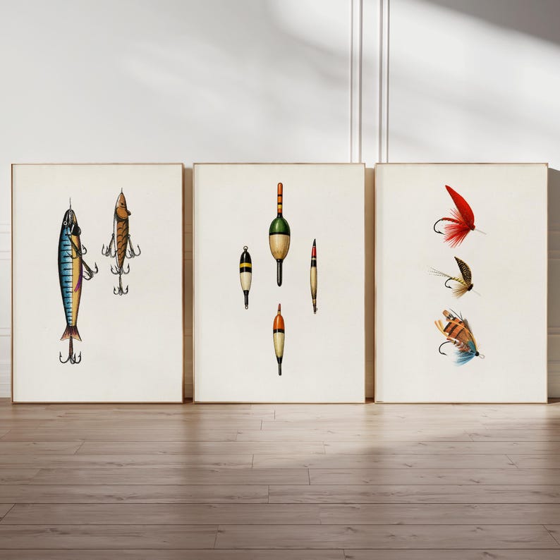 May include: Three framed prints featuring vintage fishing lures and flies. The left print shows a blue and yellow lure with three hooks. The center print displays various bobbers. The right print showcases colorful fishing flies with hooks.