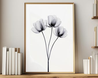 Puede incluir: Una impresión en blanco y negro de tres flores delicadas con pétalos translúcidos, enmarcada en un marco dorado.