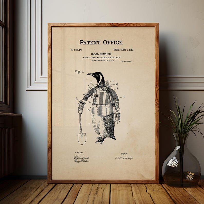 May include: A framed vintage patent print featuring a penguin with robotic arms, holding a shovel and a lantern. The print, titled "Robotic Arms for Penguin Explorer" by C.J.H. Kennedy, is dated March 5, 1912. The artwork is in black and white.