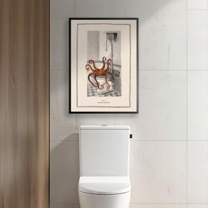Puede incluir: Una impresi&oacute;n vintage enmarcada en negro de una ilustraci&oacute;n de un pulpo en un inodoro. La impresi&oacute;n est&aacute; colgada en una pared de azulejos blancos sobre un inodoro blanco.