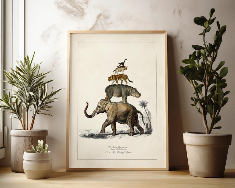 May include: Framed vintage-style print featuring an elephant, hippo, leopard, and other animals stacked on top of each other. The artwork has a beige background and is framed in a light wood. The print is displayed near potted plants.