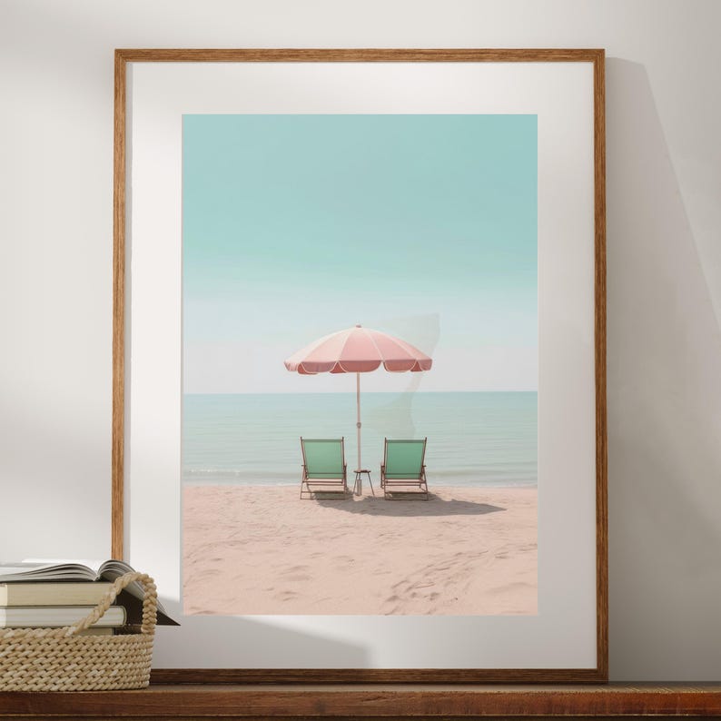 May include: Two green beach chairs sit on a sandy beach with a pink and white striped umbrella in the background.