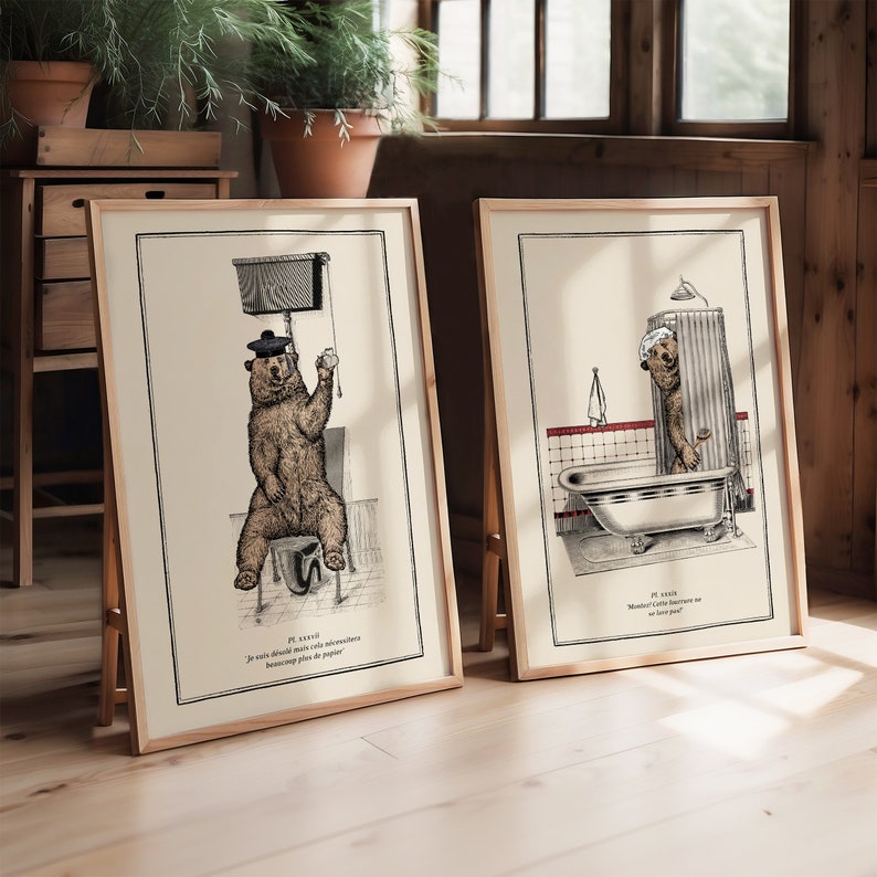 May include: Two framed illustrations of a bear in a bathroom setting. The first image shows a bear wearing a hat sitting on a toilet with the text "Je sais, j'ai d&eacute;j&agrave; dit cela, mais j'aurai besoin de beaucoup plus de papier". The second image shows a bear taking a shower with the text "Je sais, Monsieur, cette fourrure ne se lave pas".