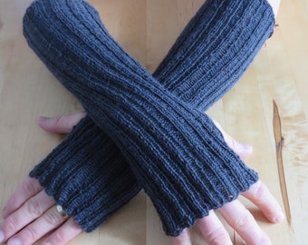 Dark gray hand-knitted wrist warmers made of sock wool with a thumb hole