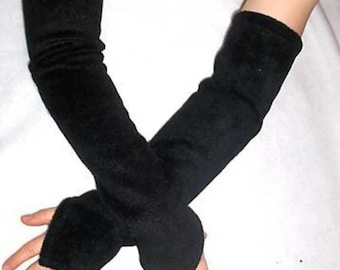 May include: Black fingerless arm warmers. These long, black arm warmers are made of a soft material. They cover the arms from the wrist to the upper arm, with a thumb hole for each hand. The arm warmers are designed to keep the arms warm.
