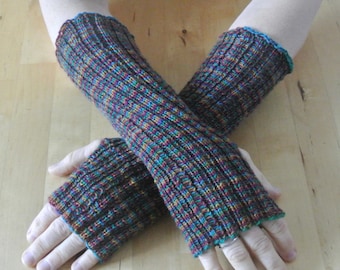 Colorful hand-knitted wrist warmers made from sock yarn with thumb holes