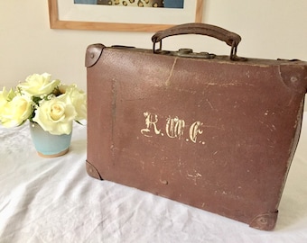 Vintage brown leather suitcase.