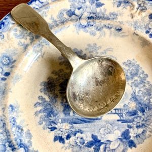 Antique silver sauce spoon.