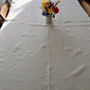 Vintage pale yellow polyester tablecloth.