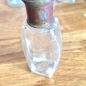Vintage clear glass perfume bottle. Metal topped.